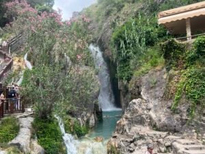 Visitor walking beside Algar River at Les Fonts d’Algar Spain