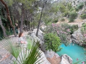 Visitor walking beside Algar River at Les Fonts d’Algar Spain