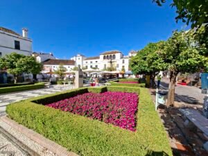 Traditional Marbella Old Town street with white houses flowers and tiled pavement