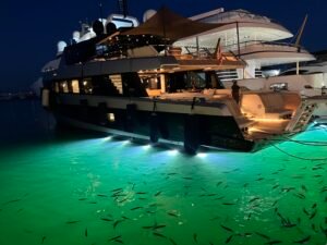 Puerto Banús Nightlife: Our First-Hand Marbella Guide Large luxury yacht illuminated at night in Puerto Banús marina, Marbella