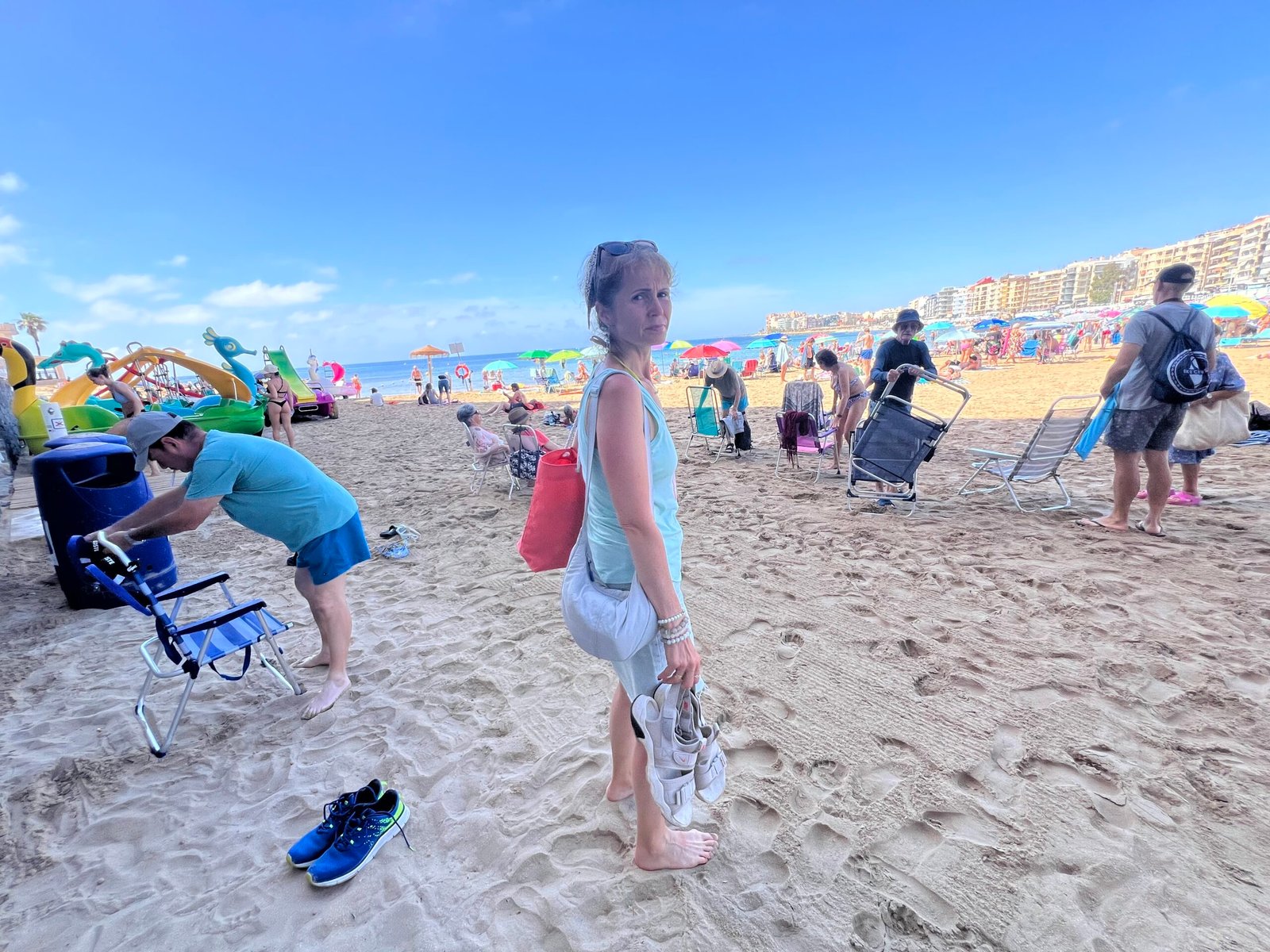 Torrevieja Beaches: Playa del Cura & Playa de Los Locos – Our Experience Busy sandy beach in Torrevieja with parasols and visitors