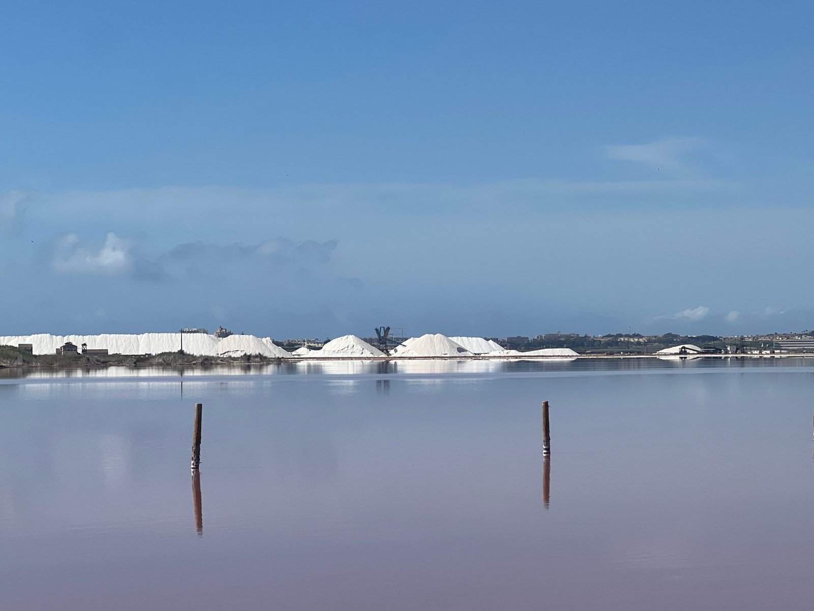 Laguna Rosa Torrevieja: Our Visit to Spain’s Pink Lake Salt piles across Laguna Rosa in Torrevieja, Spain