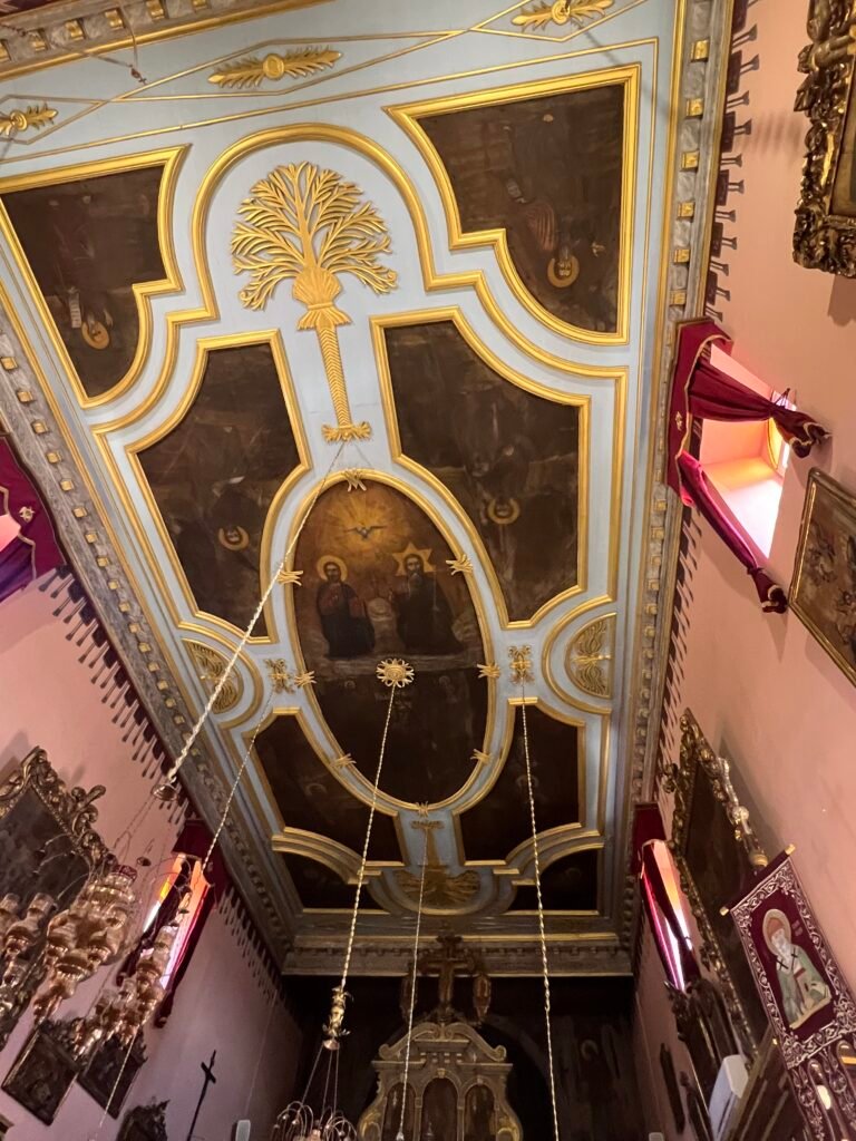 Religious ceiling paintings framed by gold and white decoration in the monastery church