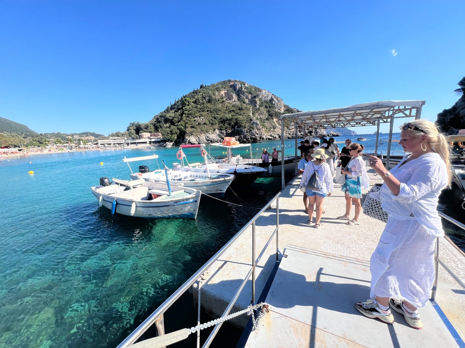Small boats moored beside the jetty in the turquoise bay