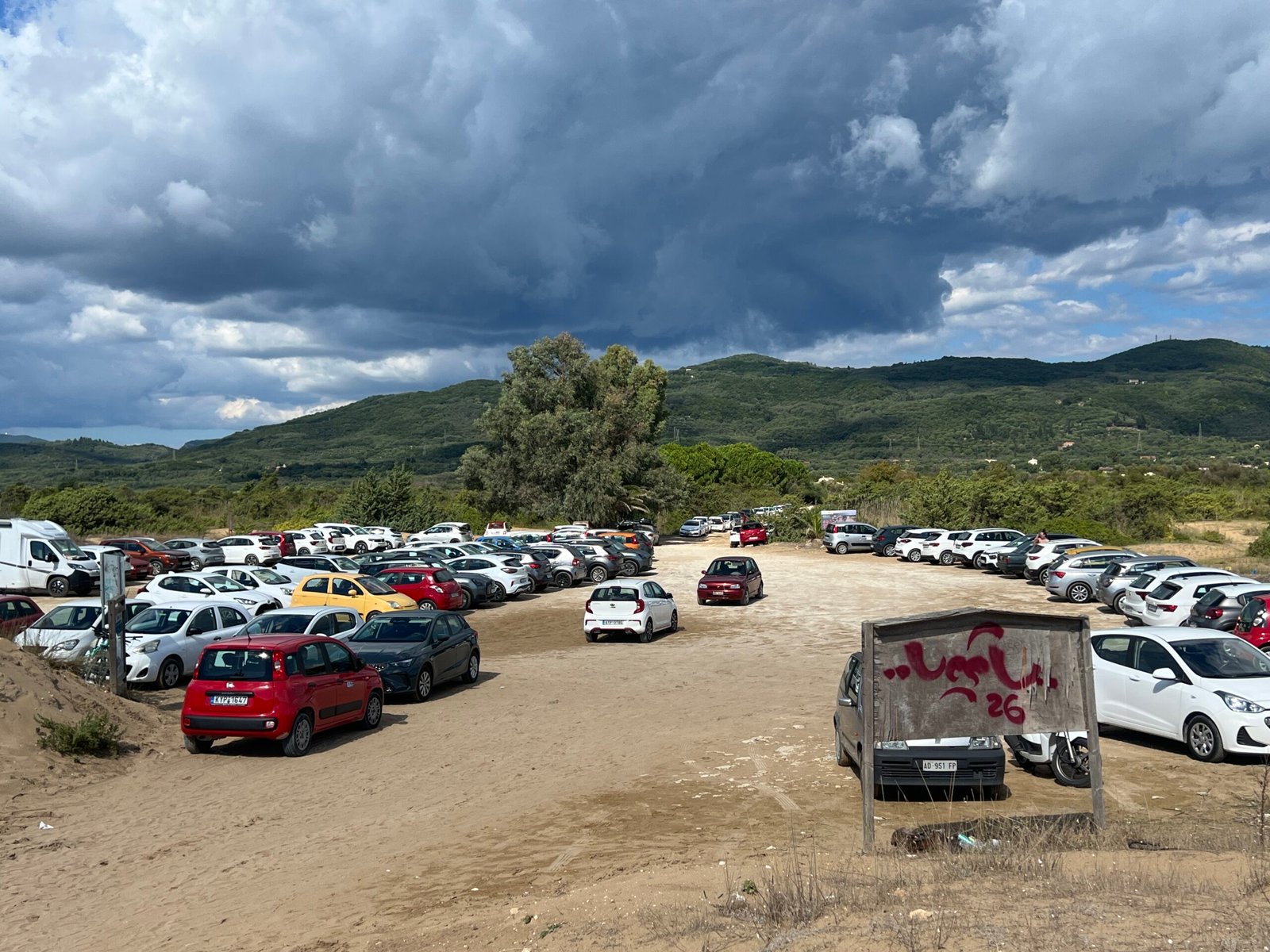 Car park immediately beside the sandy entrance to Issos Beach