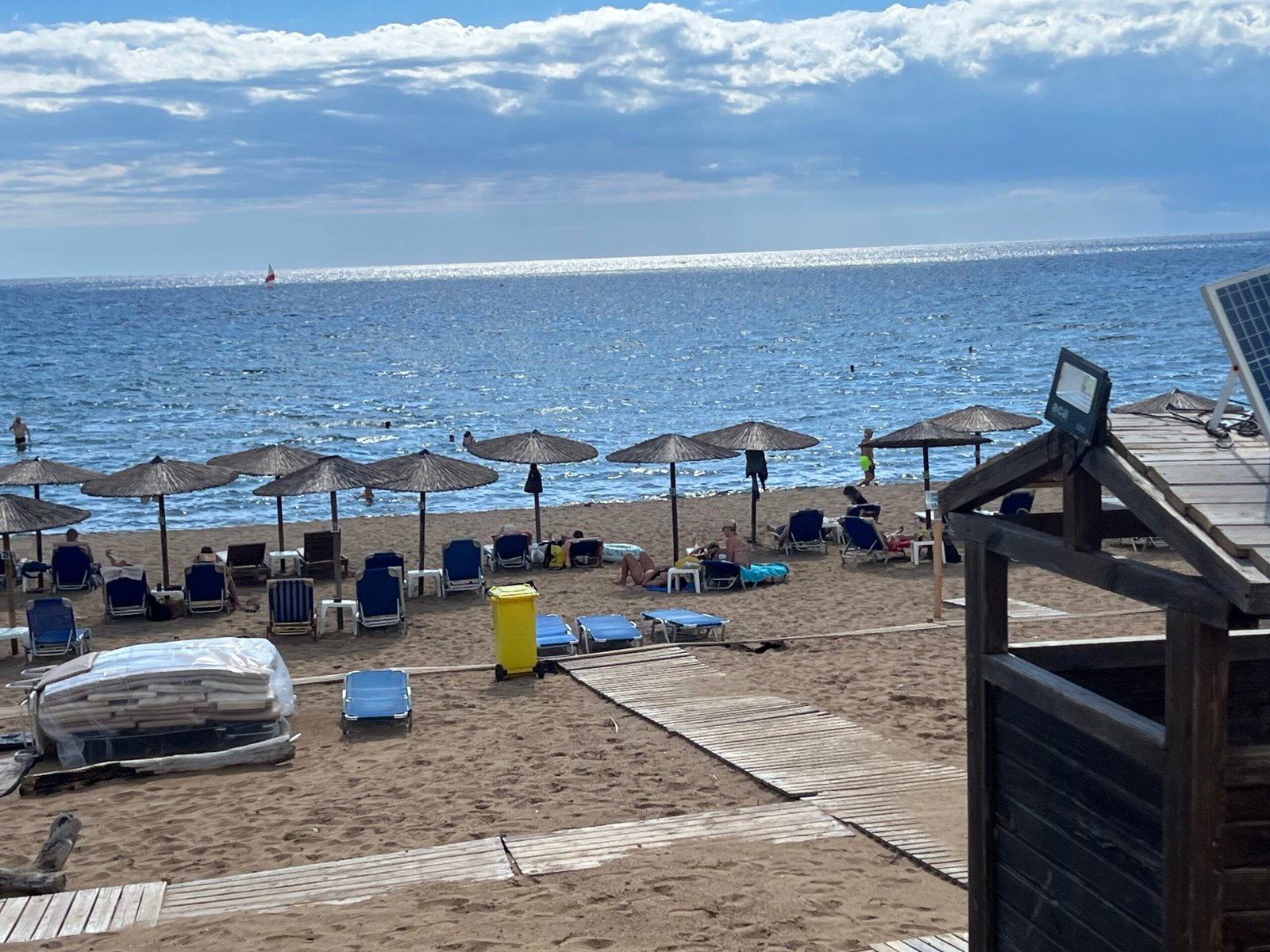 Umbrellas and sun loungers beside the sea at Issos