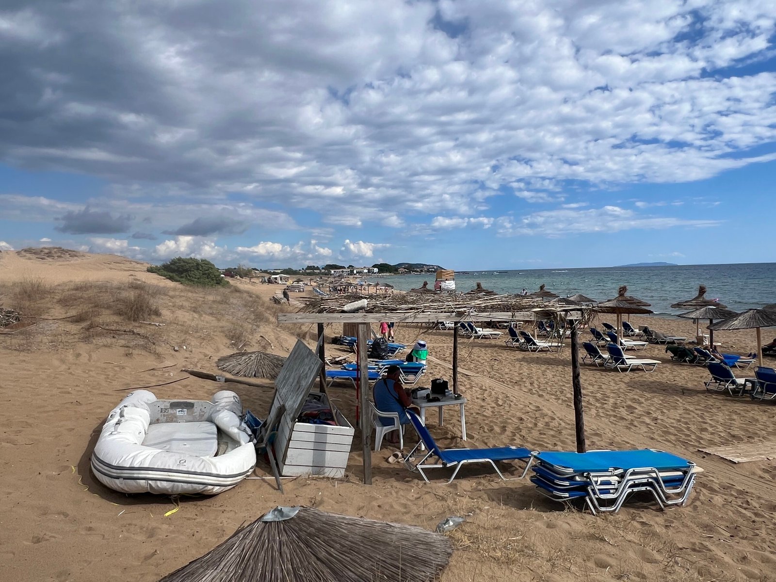 Loungers and straw umbrellas along Issos Beach
