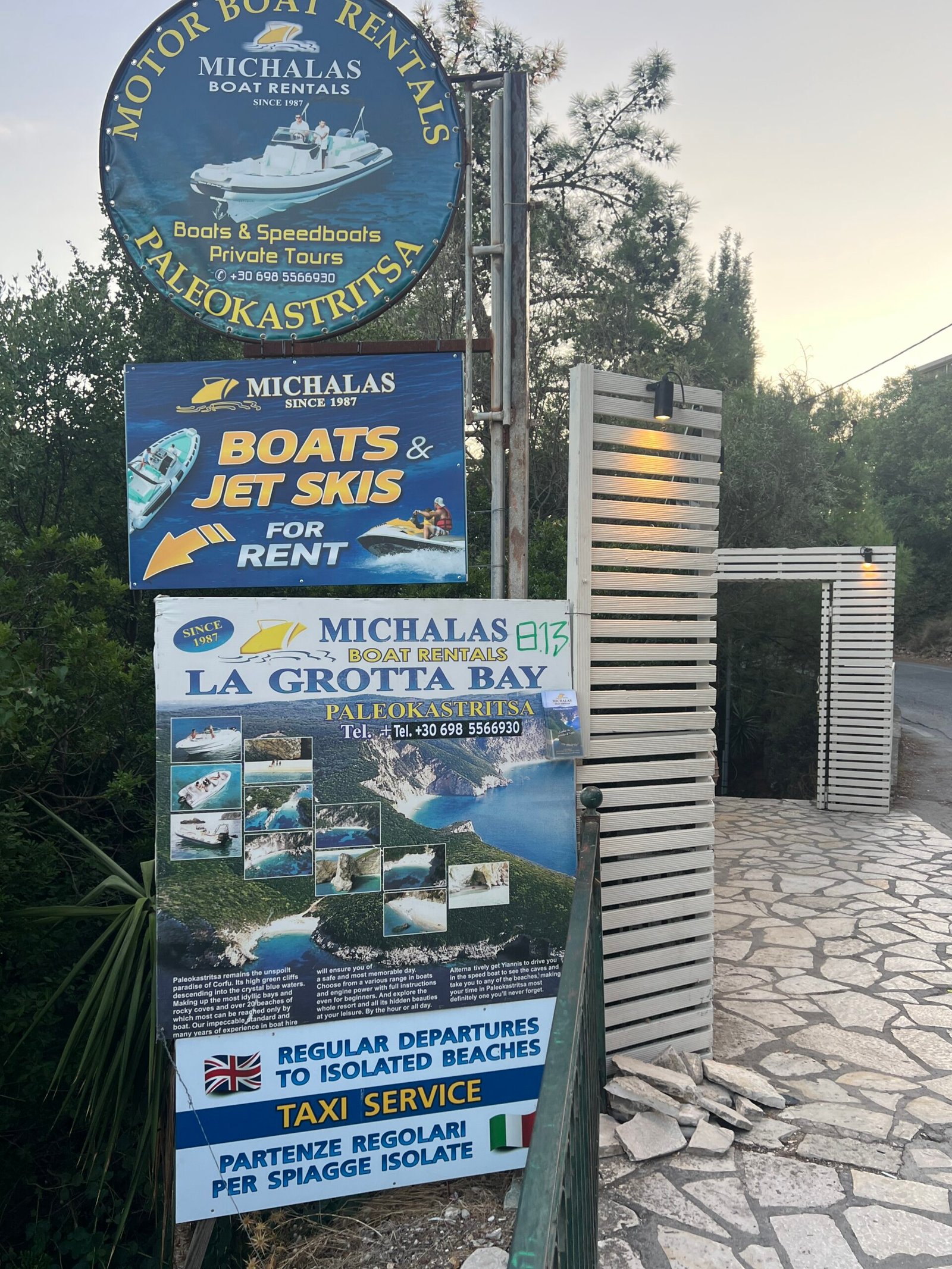Michalas boat rental signs for La Grotta Bay in Paleokastritsa