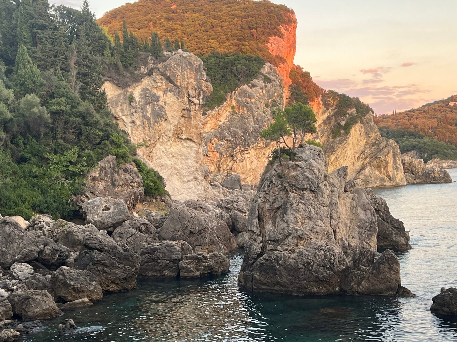 Evening sunlight on the cliffs above La Grotta bay
