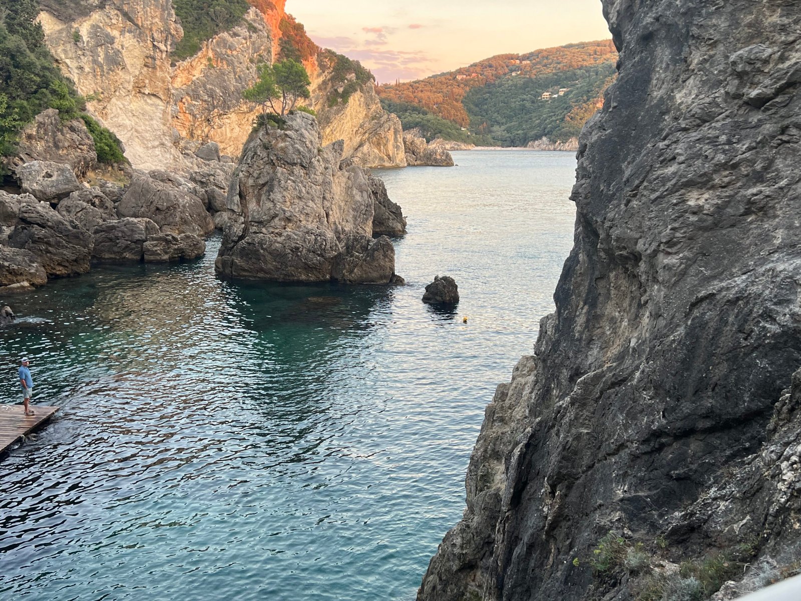 La Grotta Corfu inlet framed by cliffs in the evening light