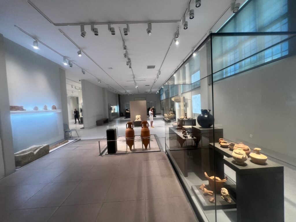 A gallery with pottery cases and larger objects displayed separately.