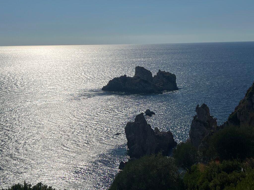 Rocky islets and sunlit Ionian Sea viewed from the Paleokastritsa headland
