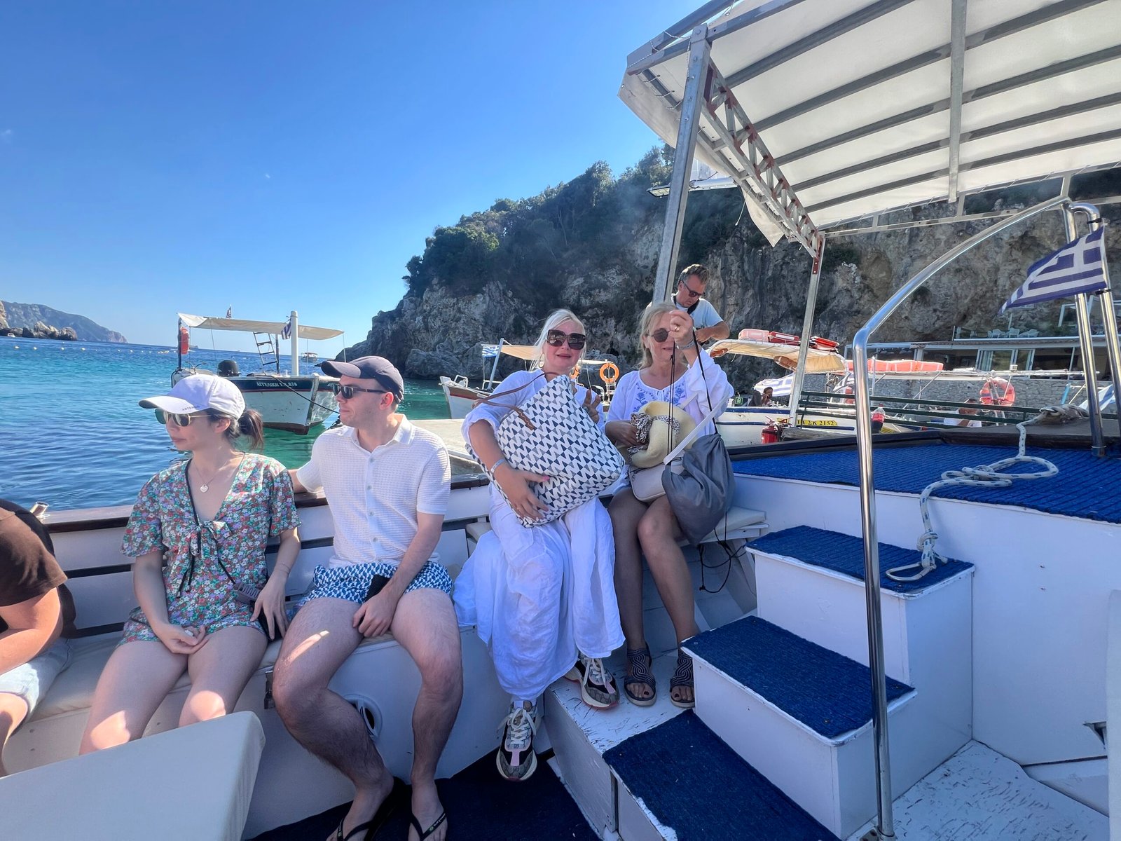 Passengers seated on a small blue and white sightseeing boat