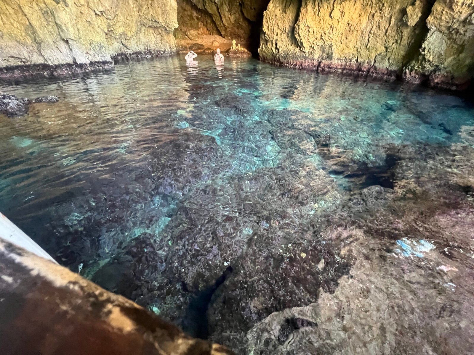 Clear turquoise water and submerged rocks inside a Paleokastritsa sea cave