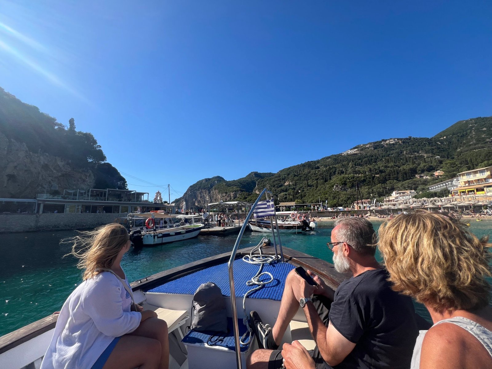Passengers leaving Paleokastritsa waterfront on a small boat