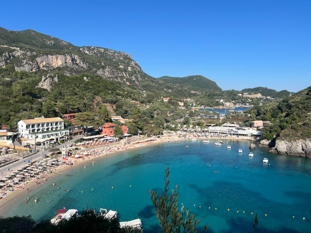 Paleokastritsa beach and turquoise bay beneath green hills in Corfu