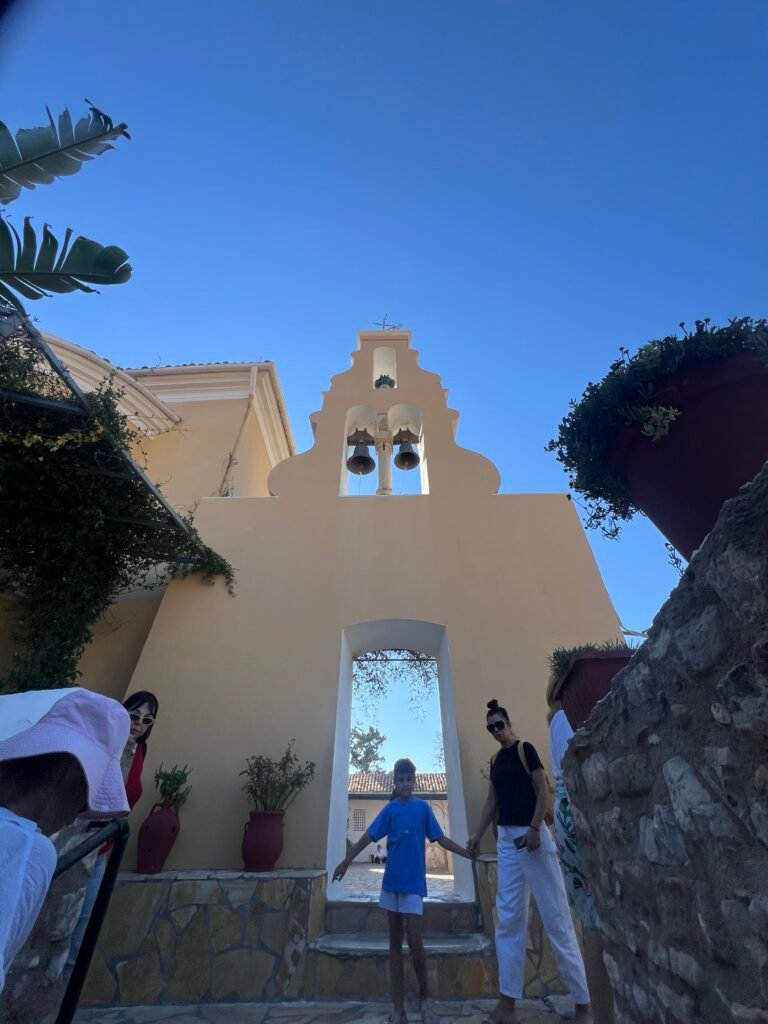 Pale yellow bell gable above a doorway at Paleokastritsa Monastery